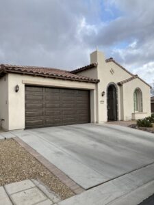 A brown paneled garage door installed on a residential home by Legacy ODS Garage Door Services in Las Vegas, NV.