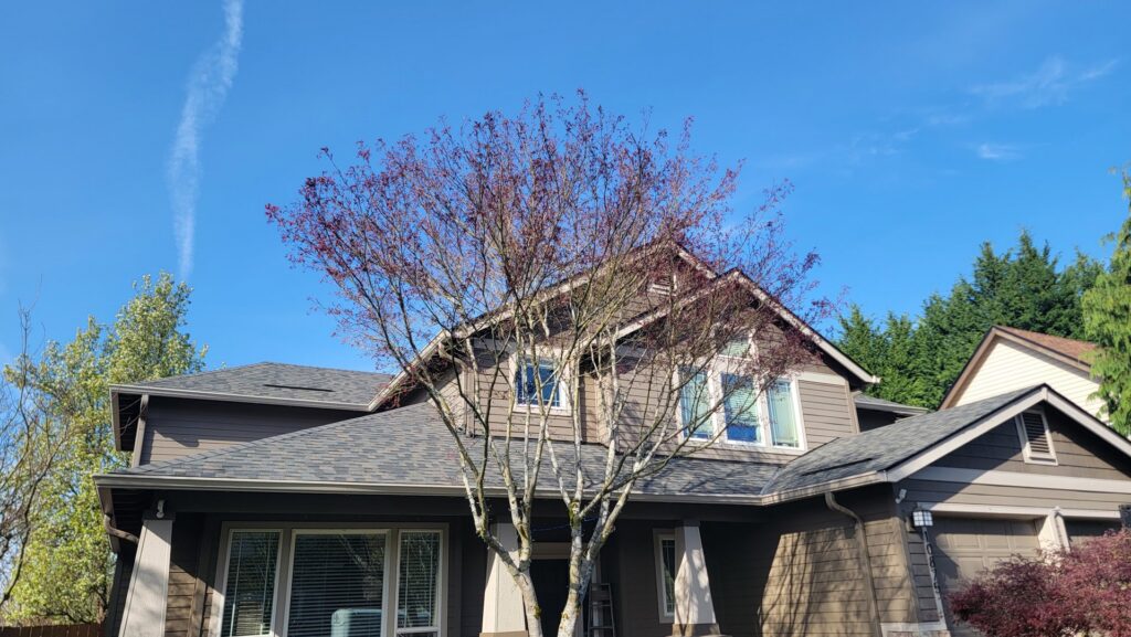A residential home with new brown siding installed by High Performance Homes in Vancouver, WA
