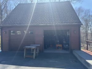 A garage with brown siding and matching garage doors, completed by J&J Rivera Roofing and Supply Co in Old Saybrook, CT