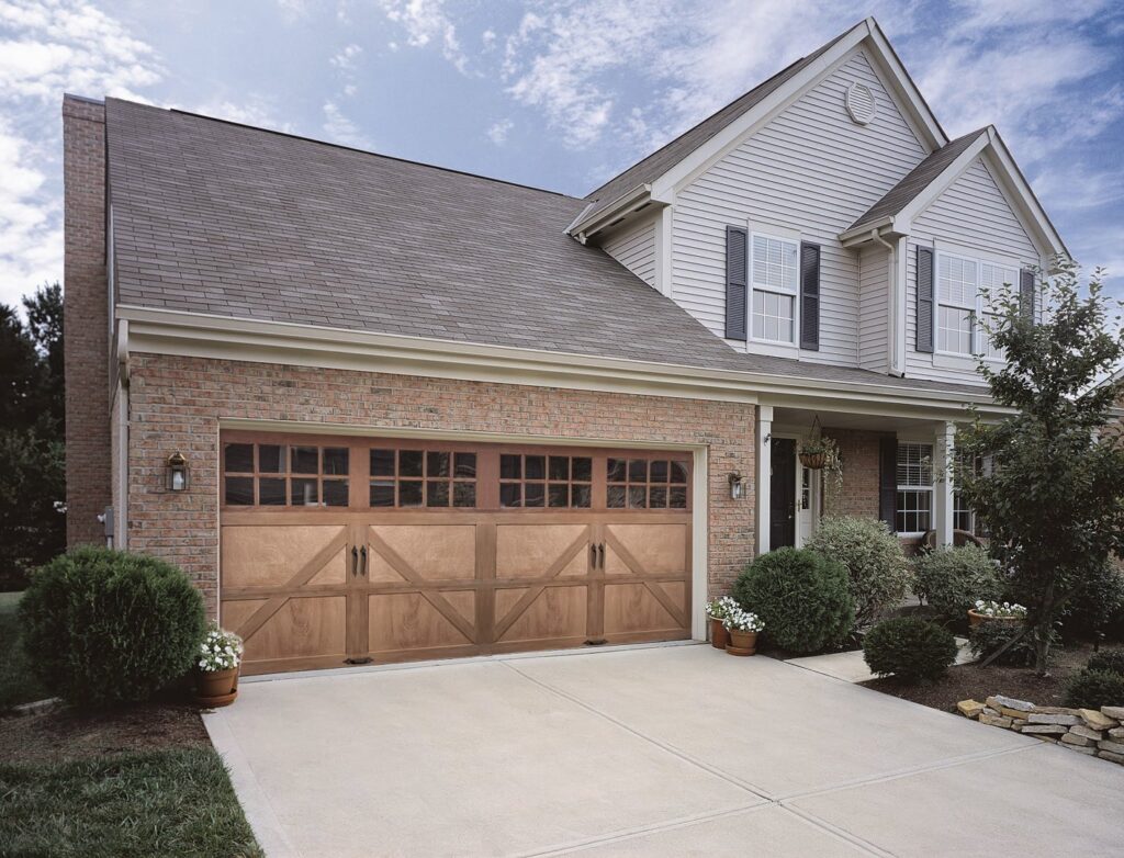 A beautiful brown wood-look garage door with multiple windows installed by The Door Man - Garage Doors & Openers in Reno, NV