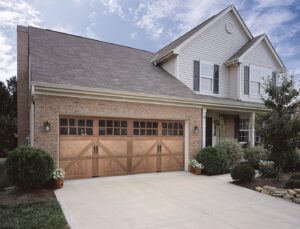 A beautiful brown wood-look garage door with multiple windows installed by The Door Man - Garage Doors & Openers in Reno, NV
