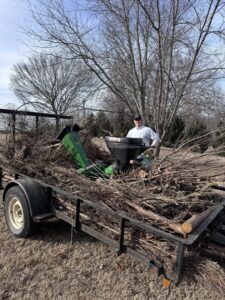 A trailer loaded with brush and debris after a cleanup by All in- Landscaping and Power-washing in Fayetteville, AR.