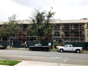 A building demolition site with scaffolding and safety barriers managed by DEMO Leaders in Los Angeles, CA