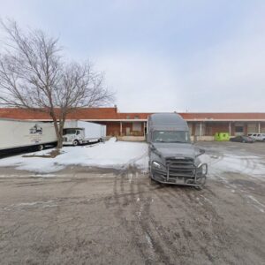 A Capital Relocation Group moving truck parked in a snowy commercial lot in Raleigh, NC.