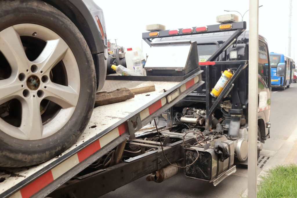 A car being securely towed on a flatbed tow truck by Southeastern Towing Inc. in Chattanooga, TN.