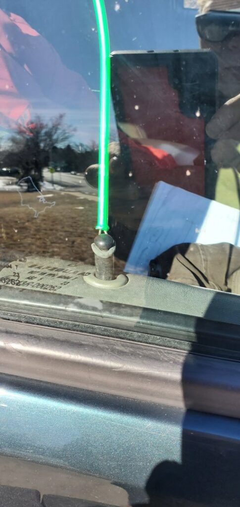A lockout tool being used to open a car door, providing lockout service by Liberty Auto Rescue in Colorado Springs, CO.