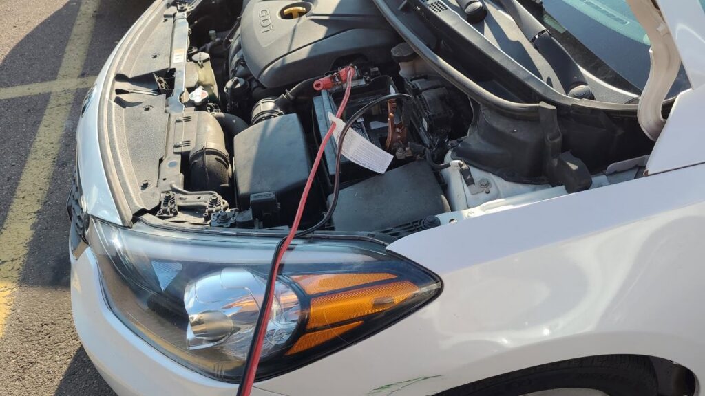 Jumper cables connected to a car battery for a jump start service by Liberty Auto Rescue in Colorado Springs, CO.
