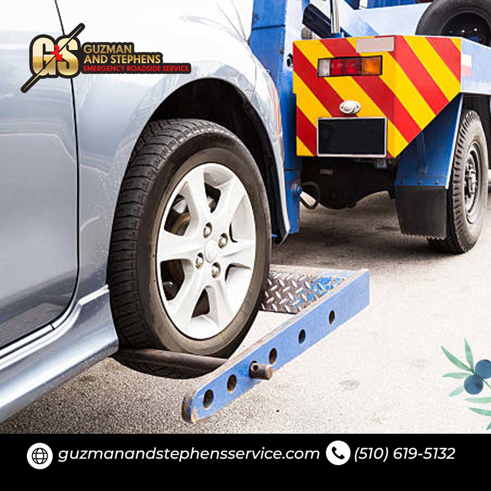 A car wheel being secured on a tow dolly by Guzman Towing Services in Oakland, CA.