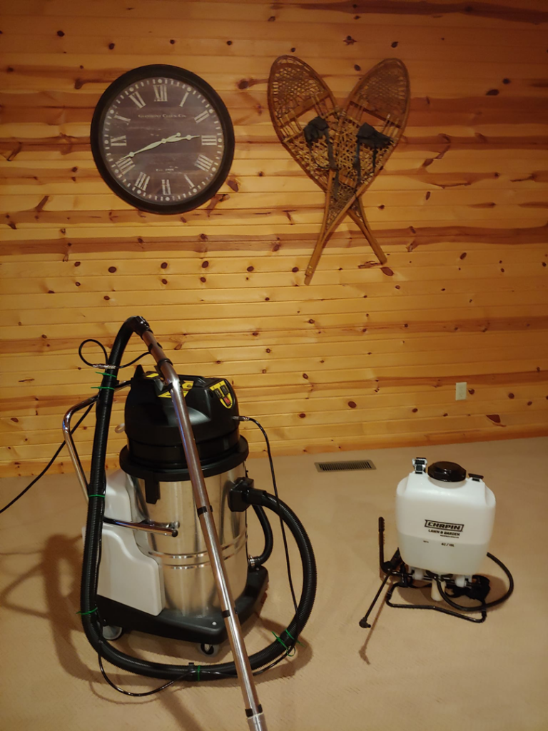 Carpet cleaning equipment, including a large machine and a sprayer, ready for use by Wholesome-Green Cleaning in Saint Croix Falls, WI.