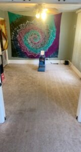 A professional carpet cleaning machine actively cleaning a residential carpeted room by K & L Cleaning Services in Pelzer, SC.