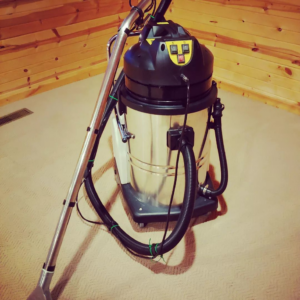 A professional carpet cleaning machine on a light-colored carpet by Wholesome-Green Cleaning in Saint Croix Falls, WI.