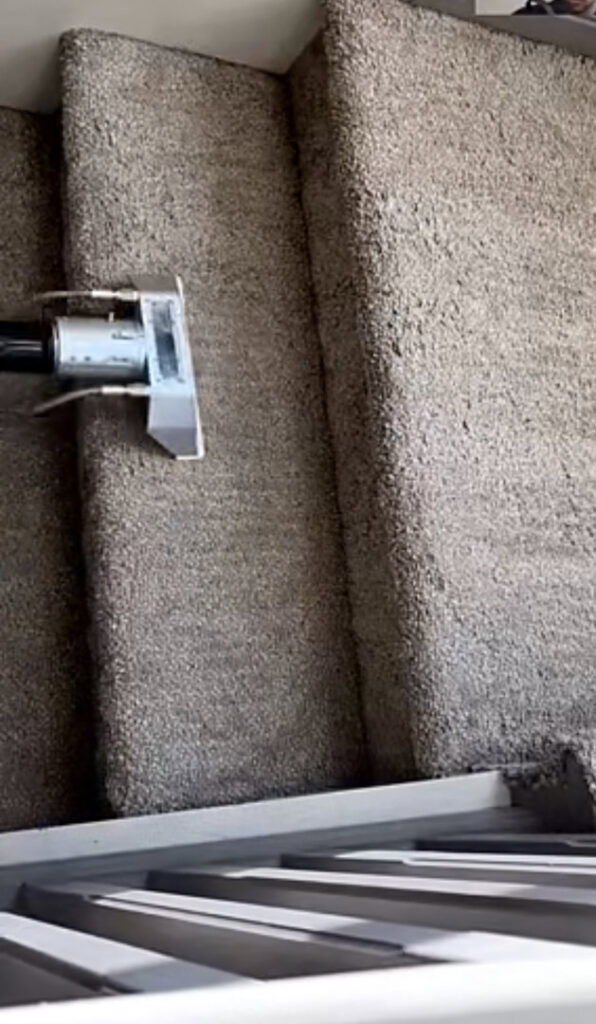 A professional carpet cleaning tool being used on carpeted stairs by Flawless Home & Business Cleaning LLC in Fargo, ND.