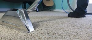 A close-up of a professional carpet cleaning wand in action on a plush carpet by Flawless Home & Business Cleaning LLC in Fargo, ND.