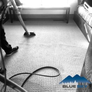 A technician performing carpet cleaning as part of water damage restoration for Clear Sky Restoration & Construction in Jackson, WY.