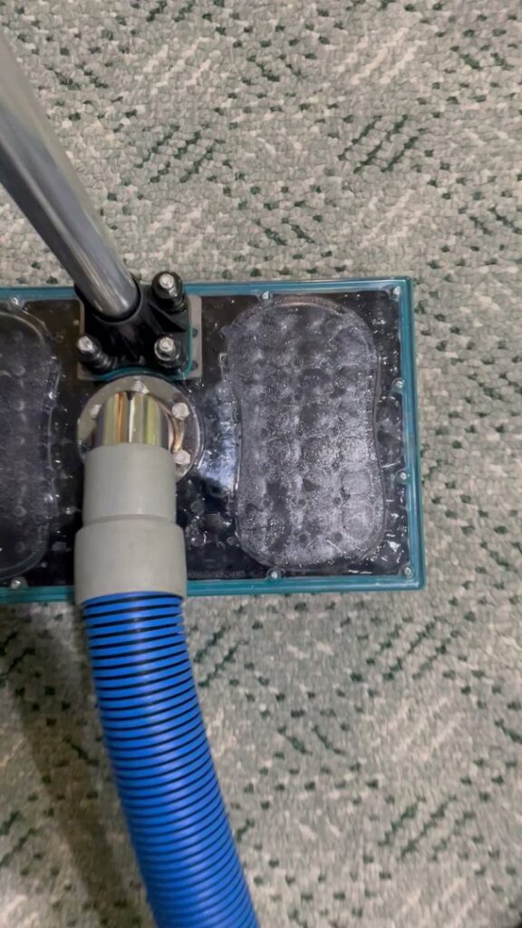 A carpet cleaning tool performing water extraction from a carpet during water damage cleanup by Idaho Disaster Pros in Idaho Falls, ID.