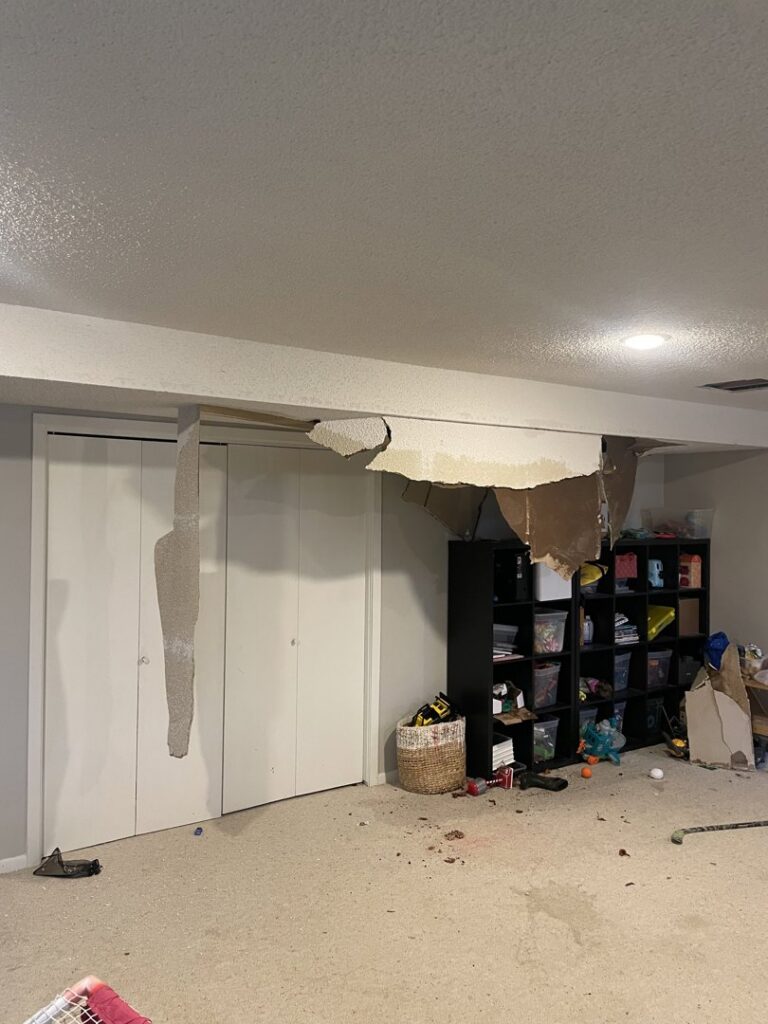 A room with a severely damaged ceiling from water damage, showing fallen drywall, by Viking Restoration Services in Rochester, MN.