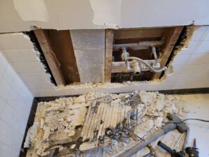 Ceiling and wall demolition revealing pipes, part of water damage repair by 1d Remedy LLC in Mechanicsburg, PA