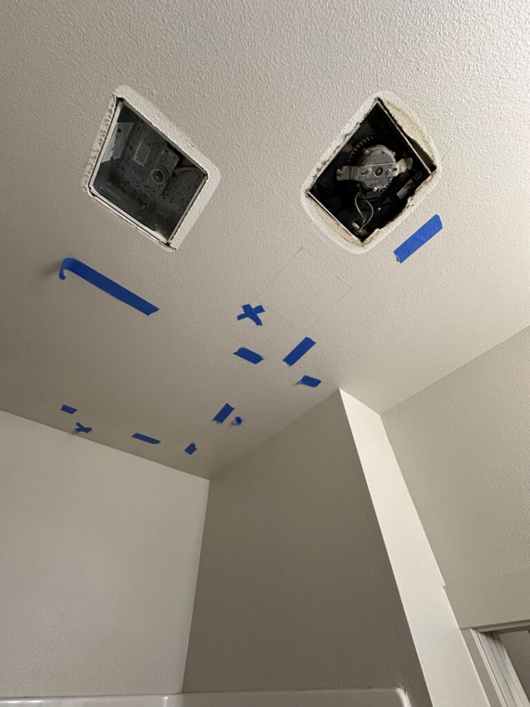 Ceiling with blue tape marking areas for moisture assessment and open vents for drying by The Recover Tech Restoration in Vancouver, WA.