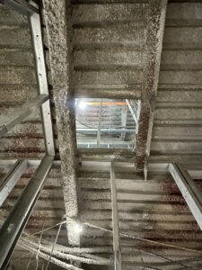 A rectangular opening precisely cut into a concrete ceiling, showcasing demolition work by Valute Demolition in Jacksonville, FL.