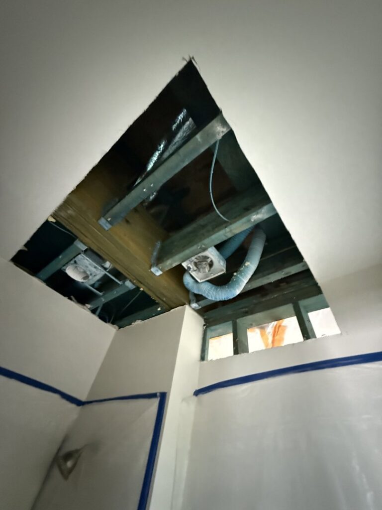 A ceiling with a large section removed, exposing beams for water damage repair by Minutemen Property Damage Services in North Charleston, SC.