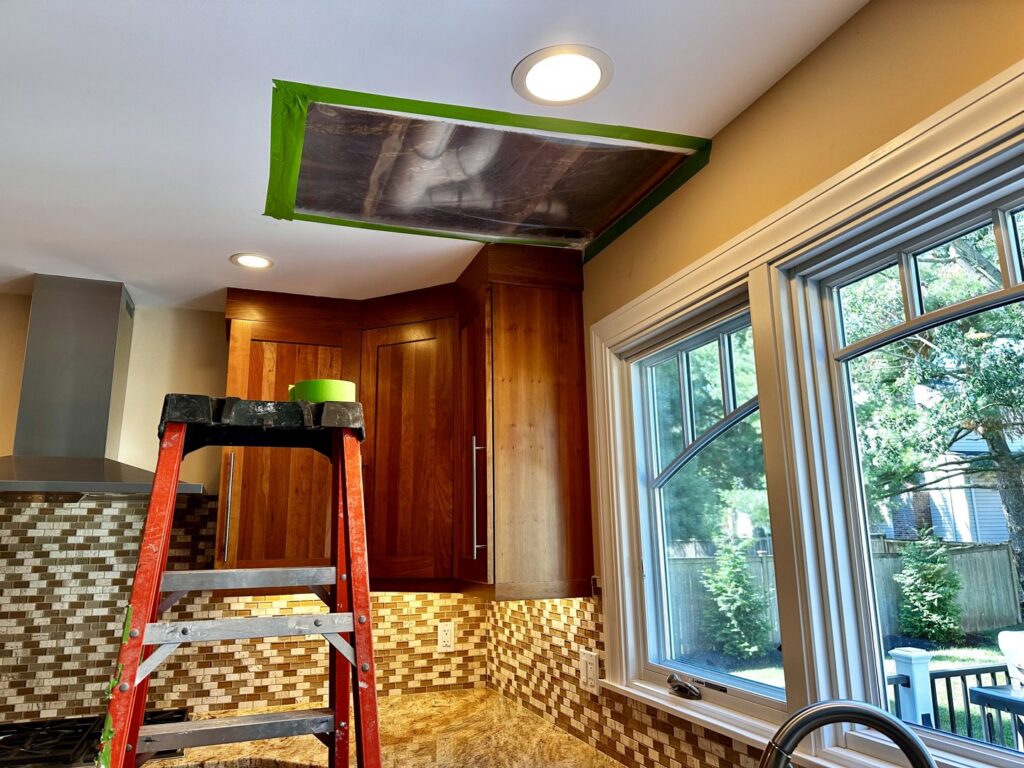 A ceiling vent sealed with plastic and tape for targeted drying during water damage restoration by New Method Restoration in Edison, NJ.