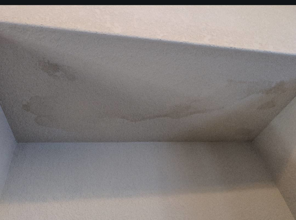 Clear water stains visible on a ceiling, indicating water damage addressed by Exterior Repair Medics in Manhattan, KS.