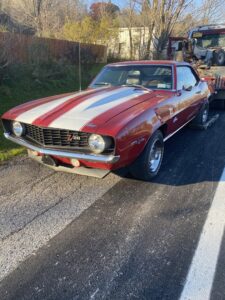A classic car being transported on a flatbed tow truck by RonniesTowing&Recovery in Bryan, TX