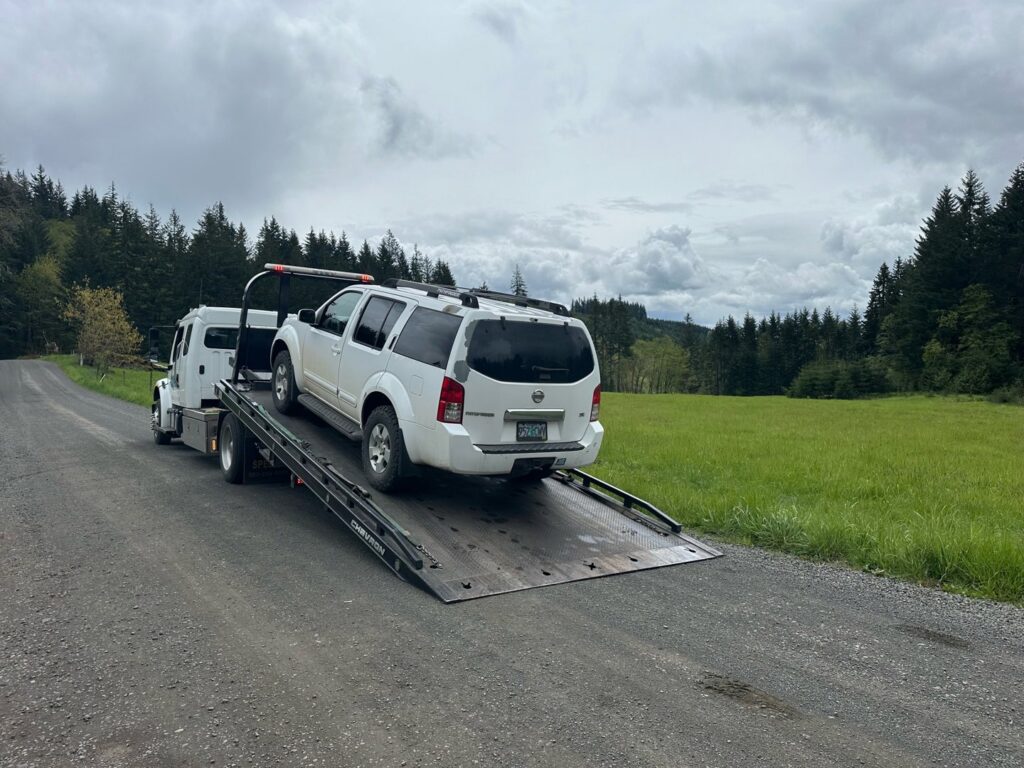A classic brown car being towed with dollies by Speed's Towing in Vancouver, WA.