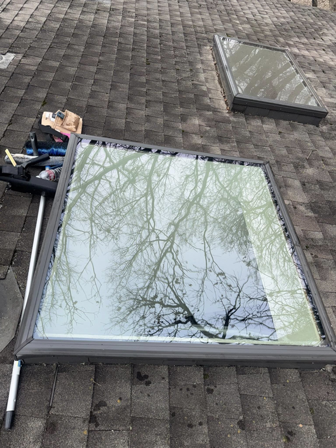 A comparison of a clean skylight and a dirty one on a roof, showcasing the effectiveness of Exterior Wash Pro LLC in Springdale, AR.