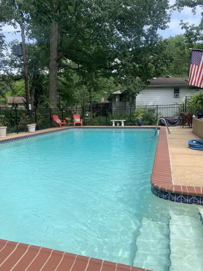A sparkling clean backyard pool with steps, showcasing the excellent results of service by Chlorine Clean Pool Services in Wilmington, DE.
