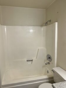 A clean bathroom featuring a bathtub, shower, and toilet, professionally serviced by Cleaners of Arizona in Chandler, AZ.