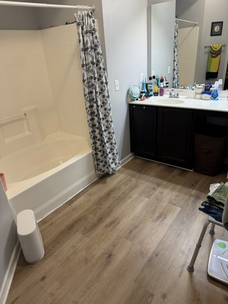 A clean bathroom featuring a spotless bathtub and organized vanity, cleaned by Maribel's Cleaning Services in Raleigh, NC.