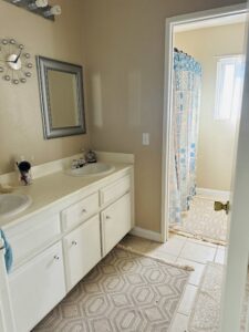 A spotless bathroom with a double vanity and a clean shower, maintained by Cleaning Service Masters LLC in Escondido, CA