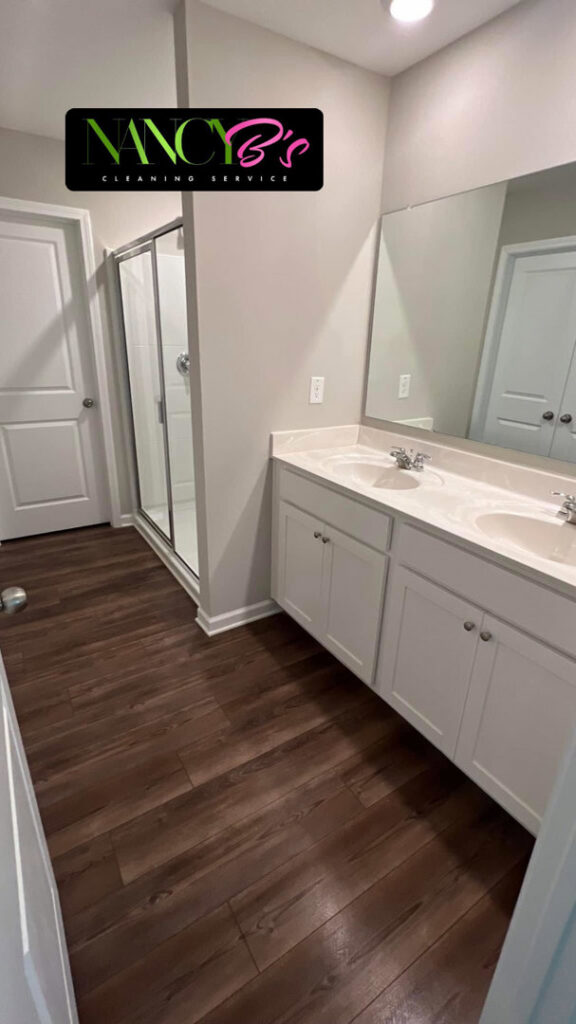 A clean bathroom featuring a double vanity and shower stall by Nancy B's Cleaning Service LLC in Atlanta, GA.