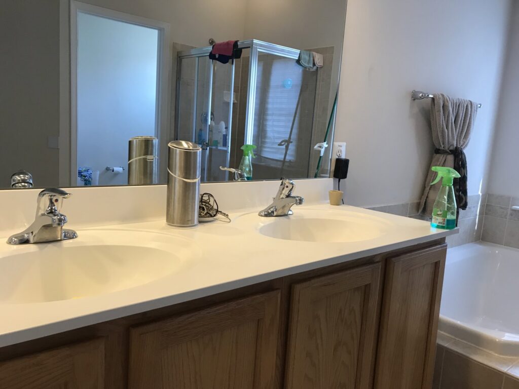 A clean bathroom featuring a double vanity, shower, and tub, sparkling after service from West & Co Cleaning Services in Laurel, MD