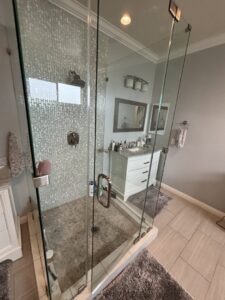 A pristine bathroom featuring a clear glass shower enclosure and a clean vanity, cleaned by Cleaning Service Masters LLC in Escondido, CA
