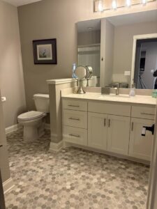 A meticulously cleaned modern bathroom with a vanity and unique hexagonal floor tiles, cared for by Estela's Cleaning Service's in Lake Elmo, MN.