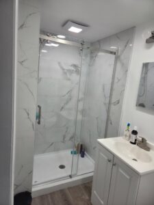 A clean bathroom with a glass shower and vanity after professional cleaning by Hm General Cleaning Services in Schenectady, NY