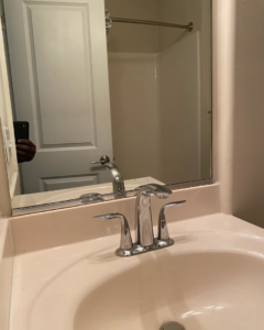 A spotless bathroom sink and shiny faucet, reflecting the quality cleaning services provided by Touches of Grace Cleaning Services in Virginia Beach, VA.