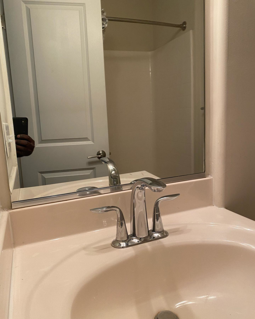 A spotless bathroom sink and shiny faucet, reflecting the quality cleaning services provided by Touches of Grace Cleaning Services in Virginia Beach, VA.