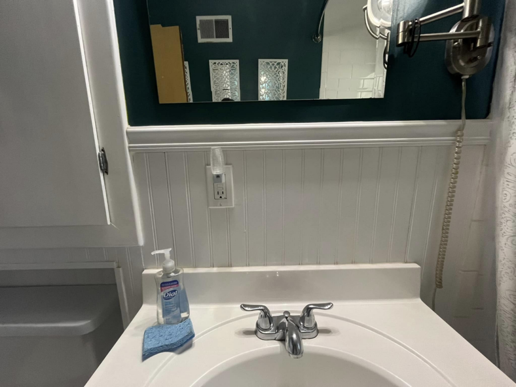 A sparkling clean bathroom sink with hand soap and a sponge, ready for use by Shine Bright Cleaning Co. in Overland Park, KS.