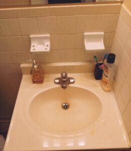 A spotless bathroom sink and vanity, cleaned by Whole New World Cleaning Service, LLC in Wilmington, DE