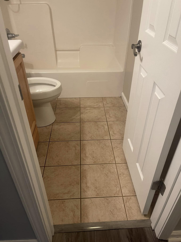 A thoroughly cleaned bathroom with sparkling tile floor, toilet, and bathtub by The Clean Solution in Eagle Lake, TX