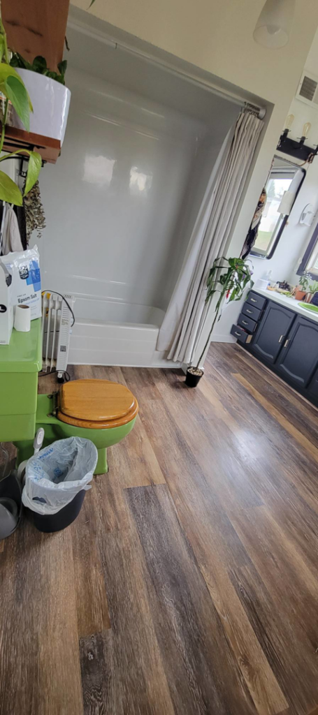 A clean bathroom featuring a toilet and bathtub, showcasing the meticulous work of Rachel Blume Residential Cleaning Specialist in Sheridan, WY.