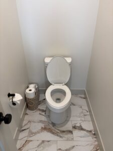 A sparkling clean bathroom with a white toilet and marble-patterned floor, showcasing Kleen Slate's results in Shakopee, MN.