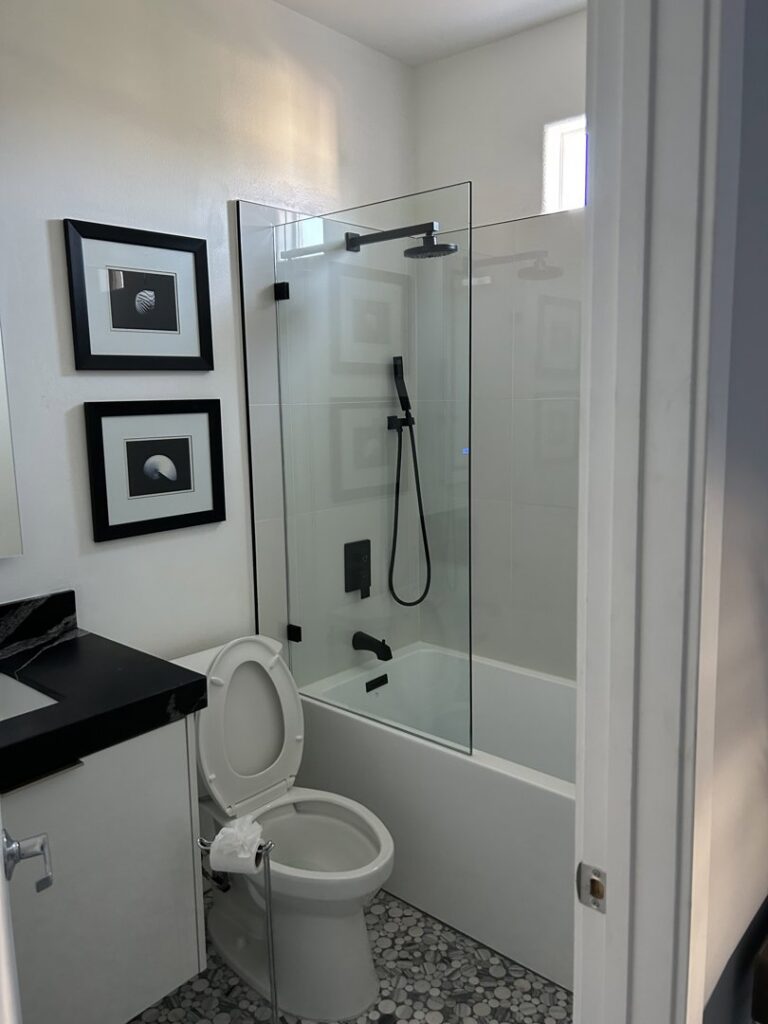A clean bathroom featuring a toilet, shower-tub combination, and vanity, professionally cleaned by JG Clean Solutions in Henderson, NV.