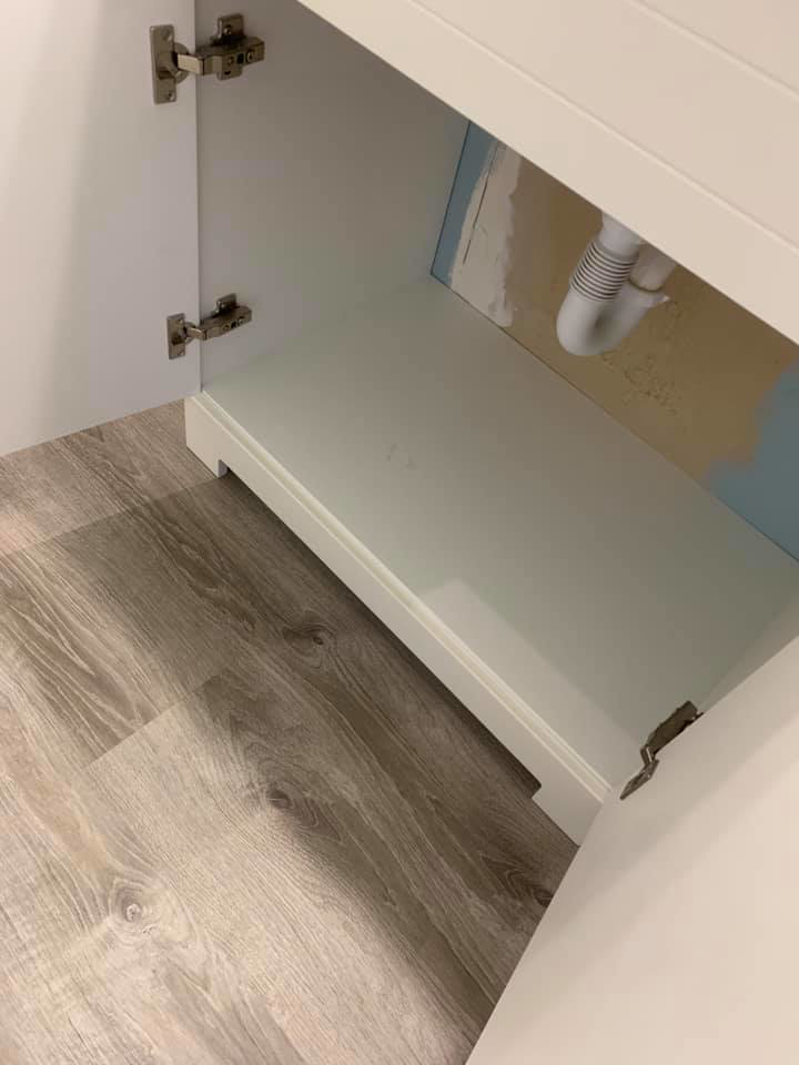A sparkling clean bathroom vanity cabinet, showcasing the thorough cleaning services of Remy the Cleaner in Indianapolis, IN.