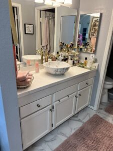 A beautifully clean and organized bathroom vanity with a decorative sink, showcasing attention to detail by Carole's House Cleaning in Tempe, AZ.