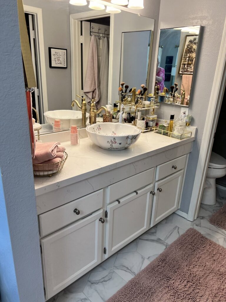 A beautifully clean and organized bathroom vanity with a decorative sink, showcasing attention to detail by Carole's House Cleaning in Tempe, AZ.