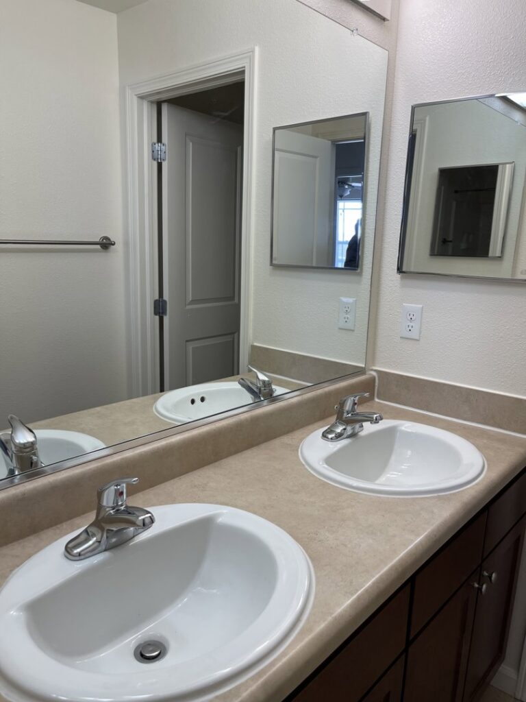 A clean bathroom vanity with double sinks and polished mirrors, reflecting thorough cleaning services from 307 Maid in Cheyenne, WY.